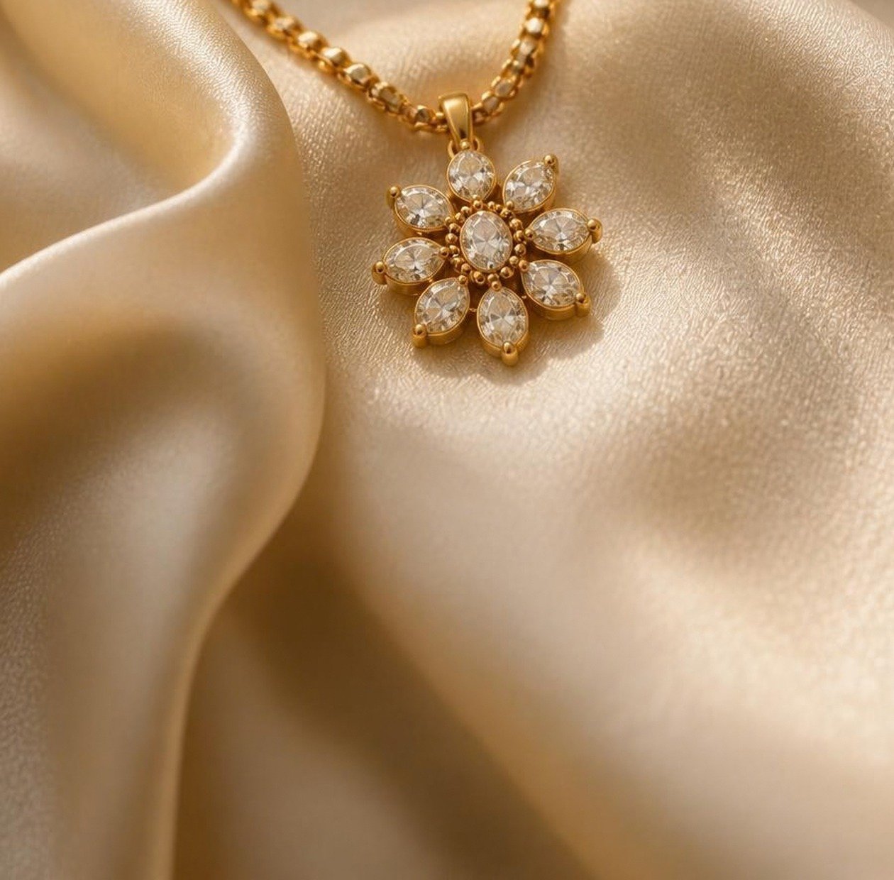 Close-up of a gold necklace pendant with ruby and pearl detailing